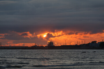 Fototapeta premium Dramatic sunset sky over the sea and the pier.