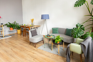 interior of stylish loft. spacious apartment with large windows, parquet on the floor and light walls. closeup view of shelving with different small things for decoration