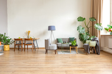 interior of stylish loft. spacious apartment with large windows, parquet on the floor and light walls. closeup view of shelving with different small things for decoration