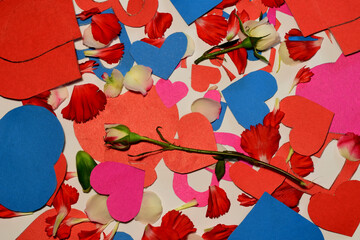 On the surface of the leaf are scattered symbols of love of the heart, roses and petals of flowers.