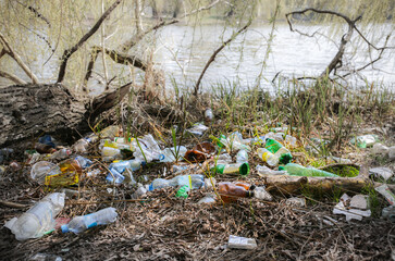 Litter plastic in the nature. Pollution of the environment. Ecological disaster. Green dirty water.