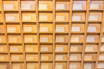 Old vintage file catalog box with many wooden index drawers in library archive