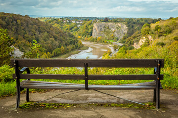 A view from Sion Hill looking down the Avon Gorge towards Avonmouth with a bench in the foreground on a bright Autumn day