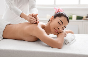 Obraz na płótnie Canvas Professional Therapist Making Back Massage To Relaxed Asian Woman In Spa Salon