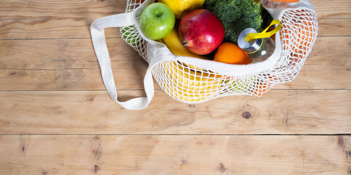 fresh fruits and vegetables in an eco bag. Zero waste, plastic free concept. Sustainable lifestyle. Reusable cotton and mesh eco bags for shopping
