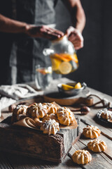 Man pours Hot tea with slices of fresh grapefruit on wooden tablet. Healthy drink, Eco, vegan.