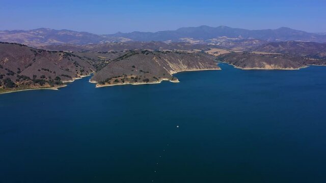 Flying over Lake Cachuma near Santa Barbara Ca. Beautiful shot of the water and California mountains.