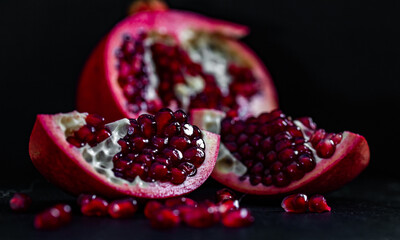 pomegranate pieces on black background