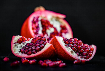 pomegranate pieces on black background