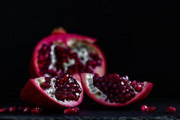 pomegranate pieces on black background