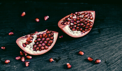 pomegranate pieces on black background