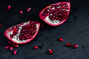 pomegranate pieces on black background
