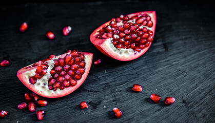 pomegranate pieces on black background