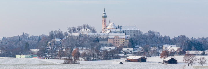 Panorama of Andechs Abbey during winter time. Snow-covered bavarian landscape with famous monastery.