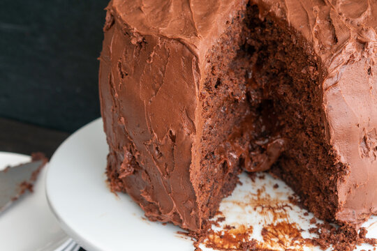 Chocolate Stout Cake with Chocolate Bourbon Sour Cream Frosting: A sliced chocolate cake with three layers