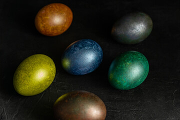 colorfull marble painted easter eggs on black background. Concept of minimal festive Easter backdrop
