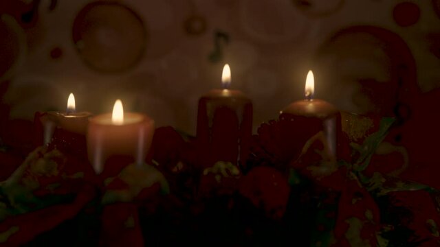 Closeup of an advent wreath with four candles burning