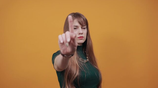 Palm arm raised air angry look straight you will not pass through facial expression harsh. Serious looking strict demands stop, pulls hand forward camera, says no, disagrees, frowns face, warning