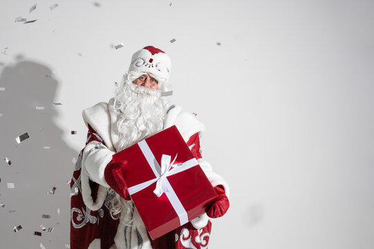santa claus with long white beard with a gift in his hands, picture isolated on white background