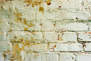 Texture of a brick wall with cracks and scratches which can be used as a background