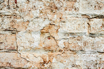 Texture of a brick wall with cracks and scratches which can be used as a background