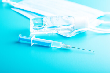 Injection syringe, sanitizer gel and protection face mask. Covid-19 coronavirus vaccination. Corona virus vaccine