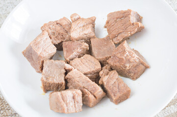 Boiled meat of beef on white plate.