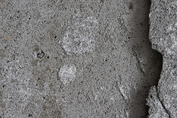 Texture of an old cracked concrete wall. Grungy gray concrete surface with shadow. Perfect for background and design. Close-up. Copy space. High resolution.