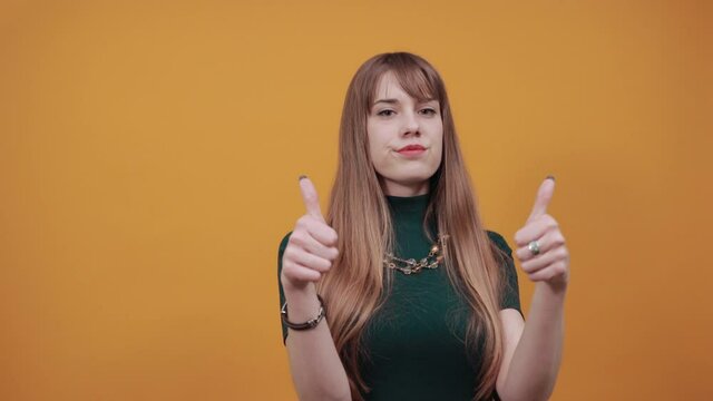 Pointing thumb over shoulder at blank space isolated. Astonished points with thumb aside. Look here. Studio photo portrait of satisfied sure, recommending cheerful nice human offering new solution