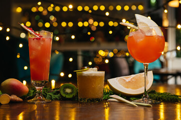 Three exotic cocktails on the table. Sour cocktail, pear cocktail and aperol spritz