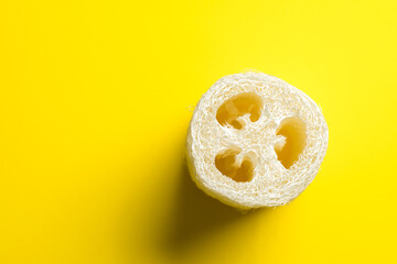 Luffa sponge for zero waste dish washing or bath on a yellow background close-up. eco friendly