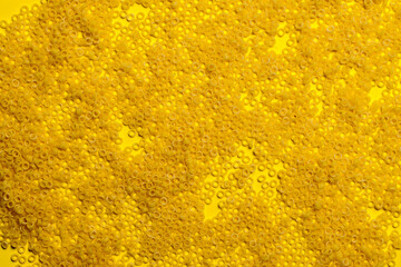 pasta in the form of small circles on a yellow background. panel. texture.