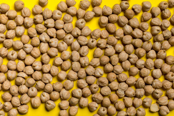 chickpea seeds on a yellow background.