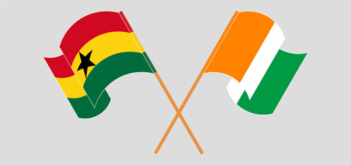 Crossed and waving flags of Ghana and Republic of Ivory Coast