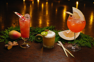 Three exotic cocktails on the table. Sour cocktail, pear cocktail and aperol spritz