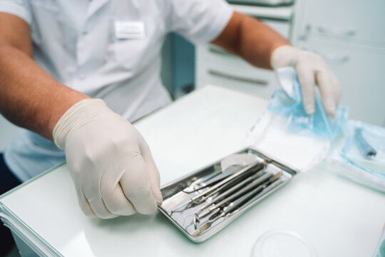 Doctor's Assistant Opens A Silver Dental Instrument Tray