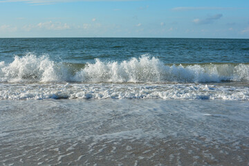 Waves on sand beach with  sky