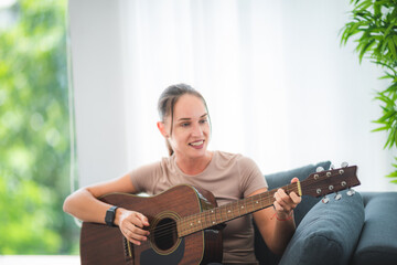 women playing guitar at ome