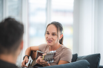 women playing guitar at ome