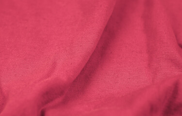 Pink crinkled fabric with visible details. background