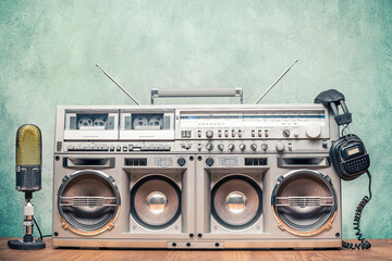 Retro ghetto blaster stereo radio cassette tape recorder boombox from circa 80s, old microphone,...