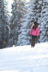 Girl on winter snowy fir tree background on ski resort