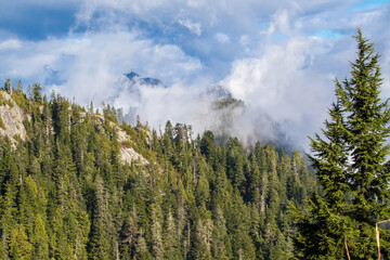 Looking down into a cloudy valley from high up a mountain