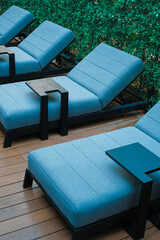 Blue poolside sofa on wooden floor - 403114144