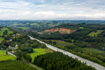 Fototapeta na wymiar Aerial view of a highway, in a hilly region, on a rainy day