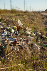 Environmental pollution. Garbage dump in the field. Illegal garbage dump