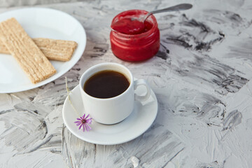 Crispbread with jam for Breakfast on a gray background. A jar of Fresh Honey with foam is next to a Cup of coffee. A minimum of calories. proper nutrition
