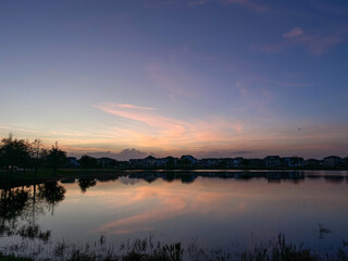 Fototapeta na wymiar Beautiful pink, orange and blue sunset reflecting on a lake.
