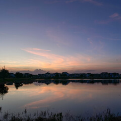 Beautiful pink, orange and blue sunset reflecting on a lake.