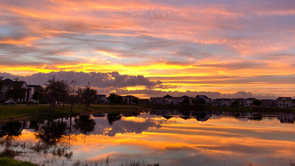 Beautiful pink, orange and blue sunset reflecting on a lake.